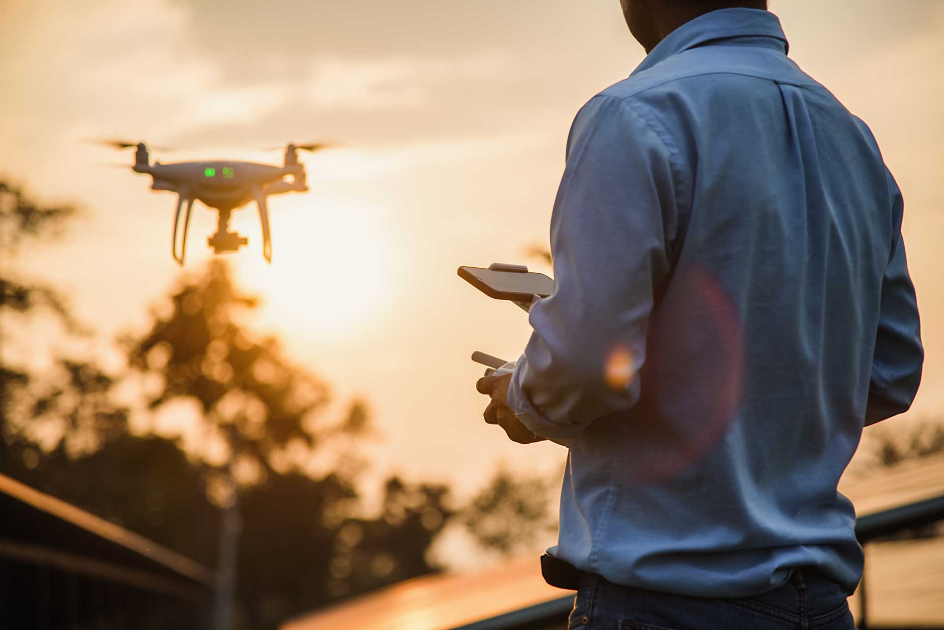 A drone pilot using a drone to inspect a building